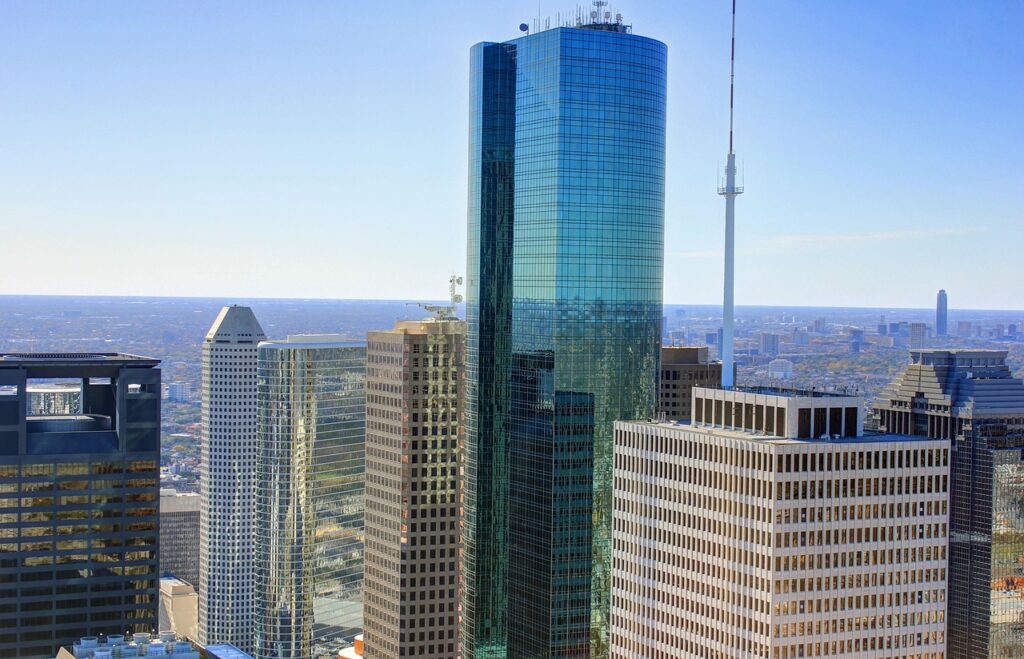 Daytime view of Houston’s downtown, with modern skyscrapers and bustling streets, showcasing the city's vibrant urban landscape and diverse architectural styles